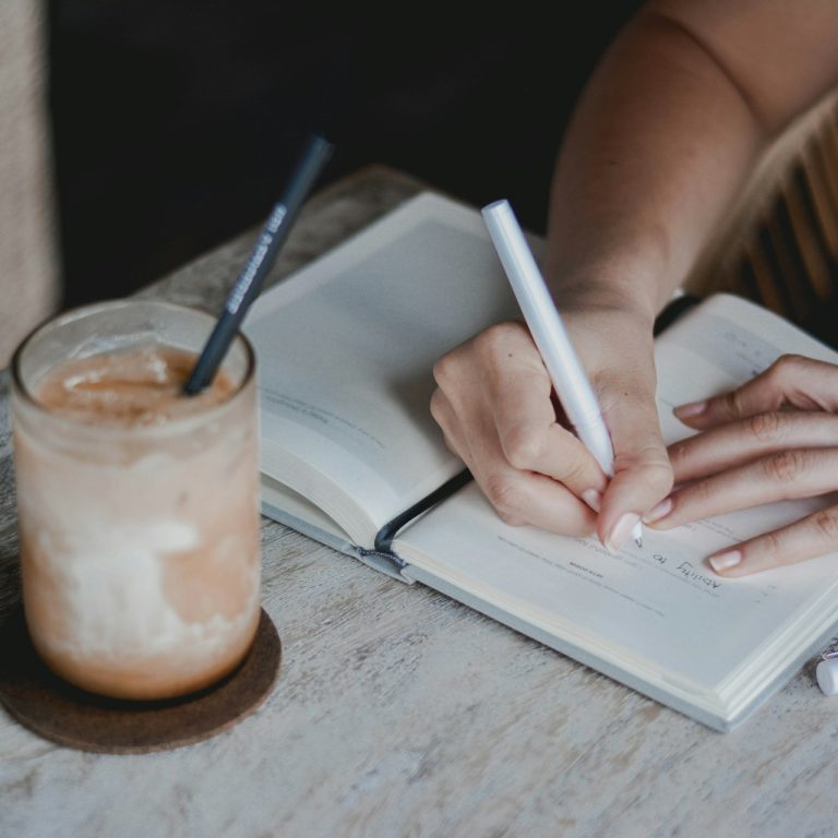 Person writing on white paper