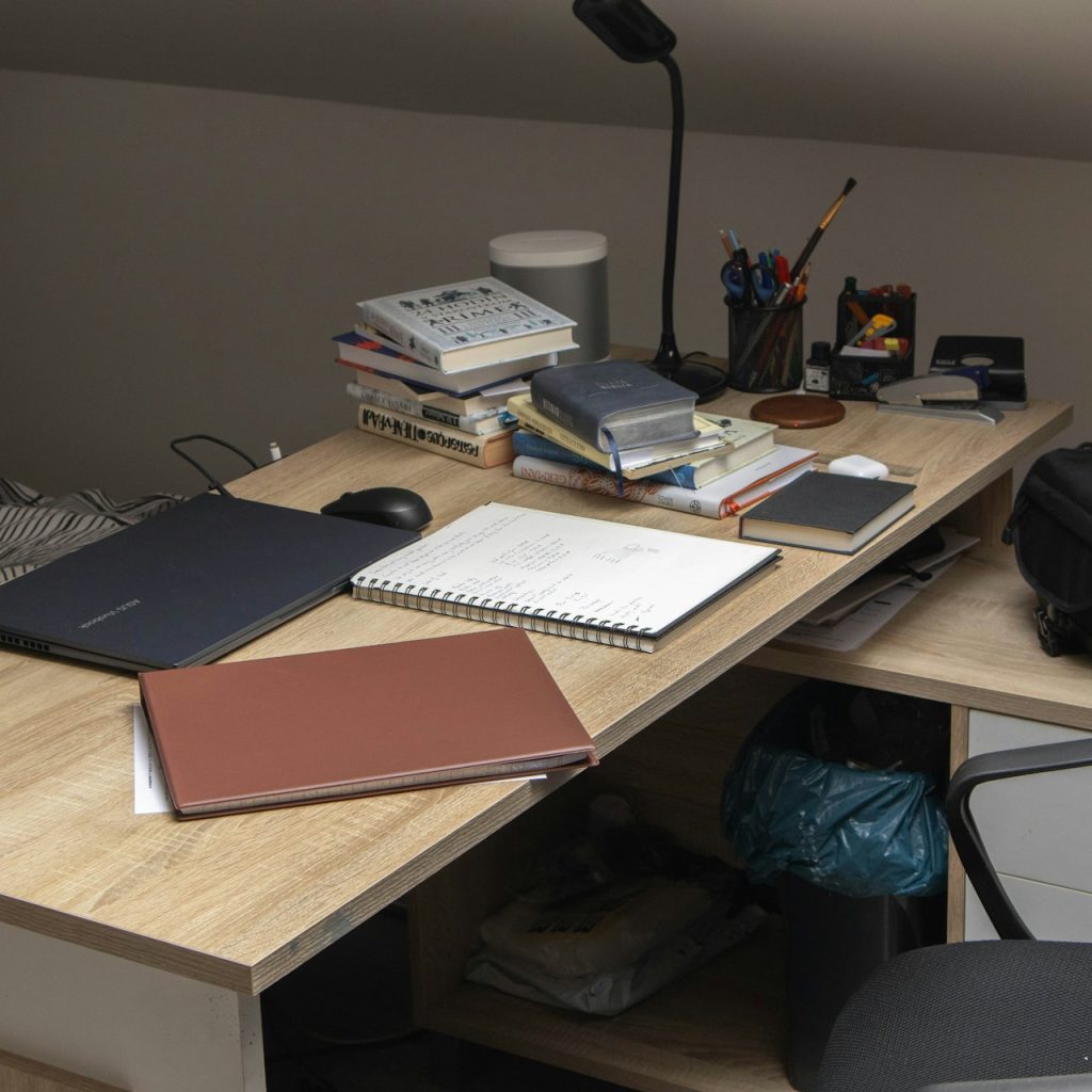 A wooden desk topped with a laptop computer