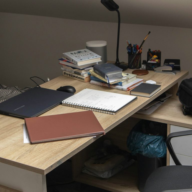 A wooden desk topped with a laptop computer